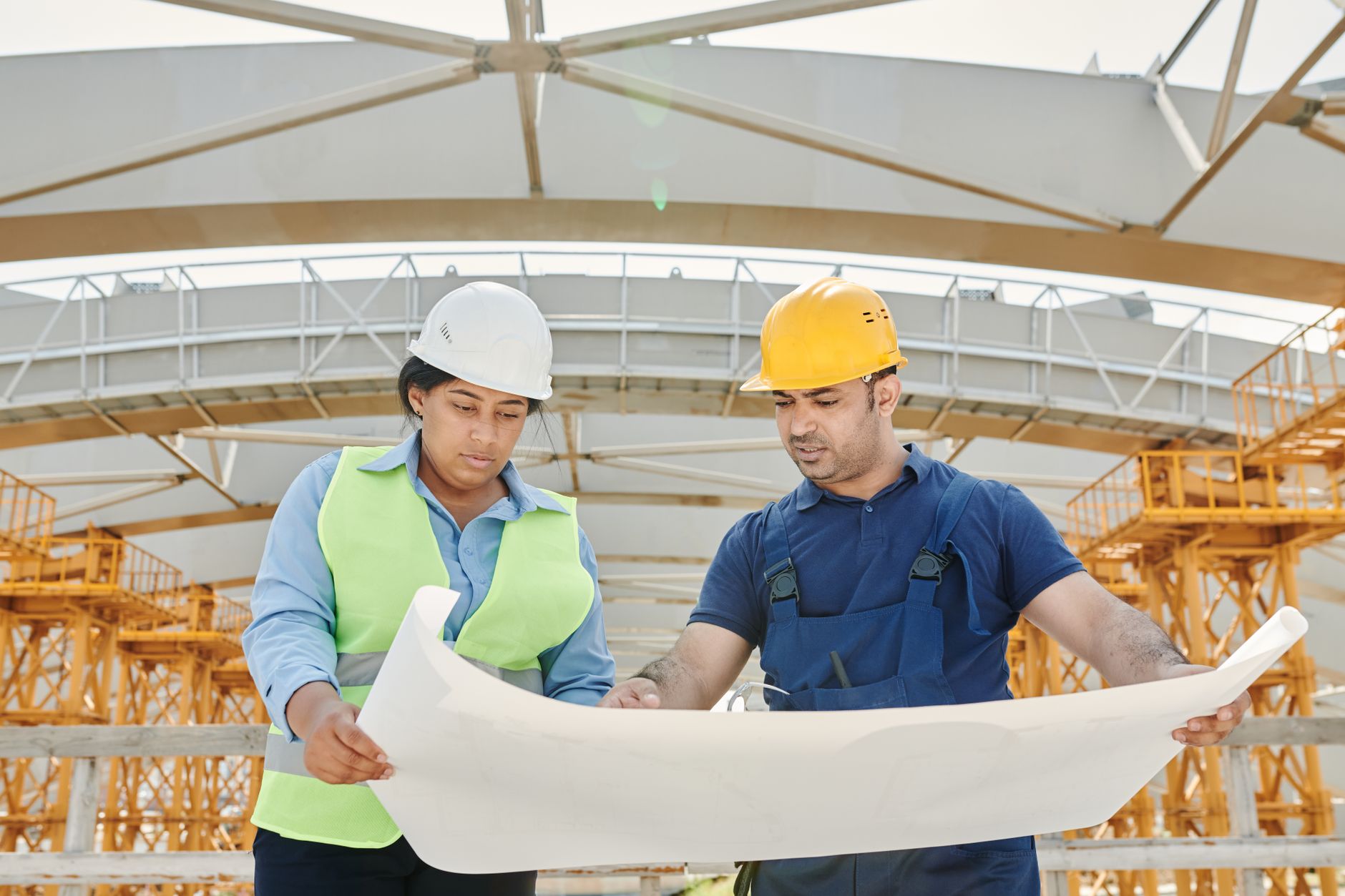 A project manager and deployment engineer review a checklist together on a tablet during the collaborative Site Acceptance Testing process.