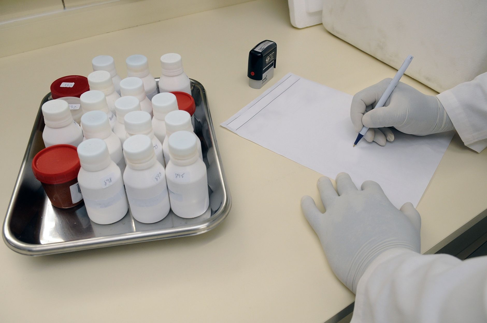 Labeled specimen tubes on a tray in a clinical setting, reinforcing the article's point that rapid, standardized lab handoffs can justify specimen delivery before other transport tasks.