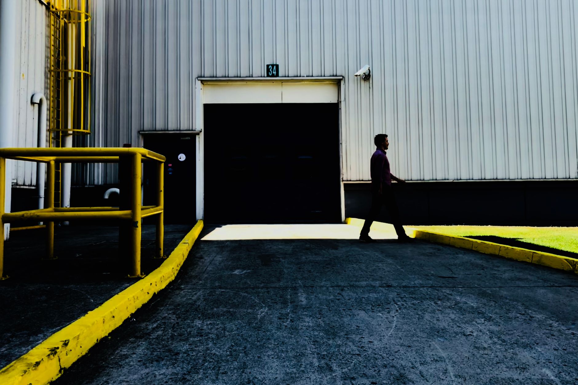 A closed roll door at a back-of-store warehouse entrance, similar to the overnight dock access Kaufland is adapting for robot docking.