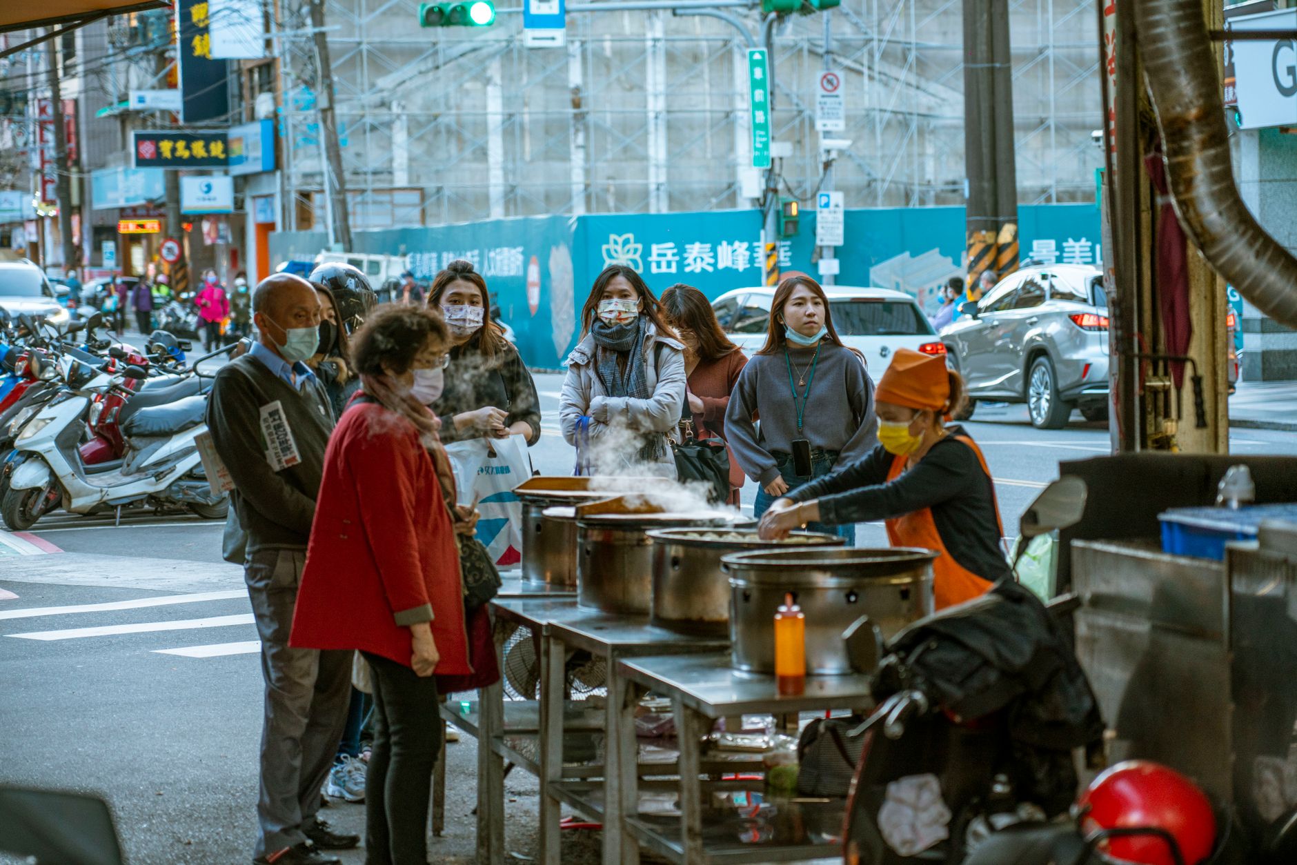 Guests lining up at separate food stalls in a shared hall, illustrating the split between tenant operations and common guest flow.
