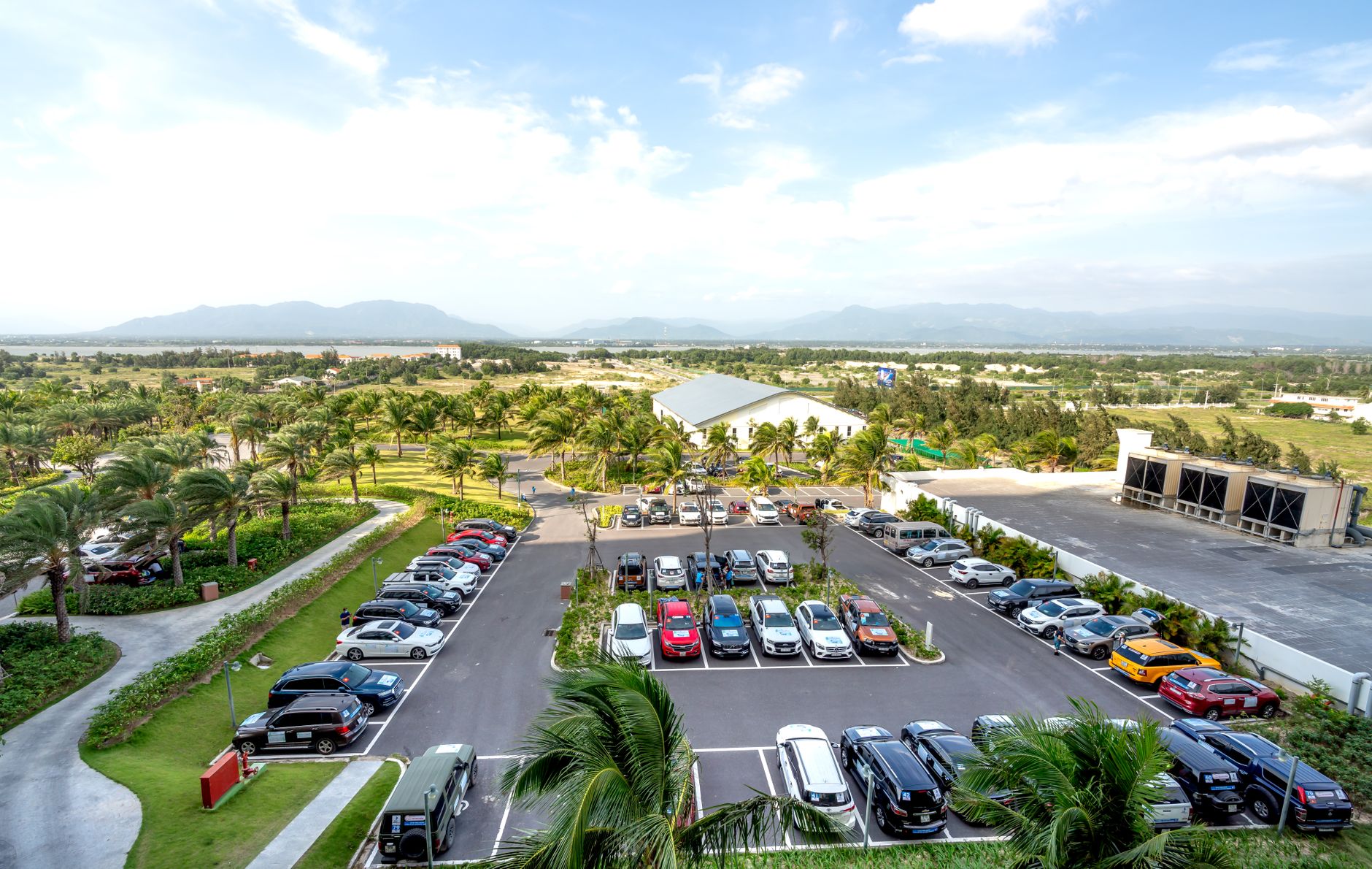 A large resort parking area and guest drop-off zone illustrate the varied outdoor surfaces a cleaning pilot must handle.