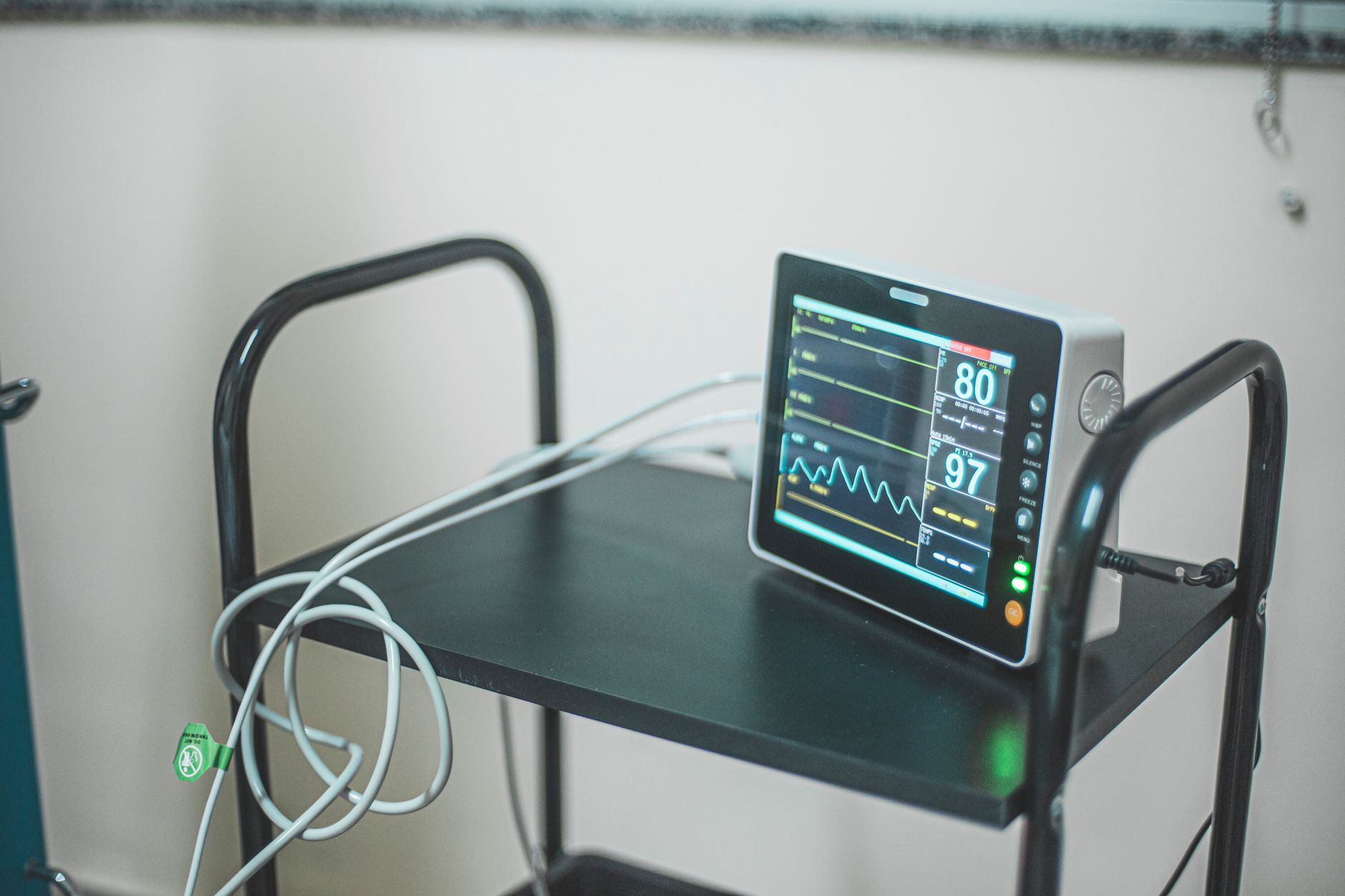 A supply cart staged in a hospital corridor, showing the kind of standardized transport work community hospitals can automate first.
