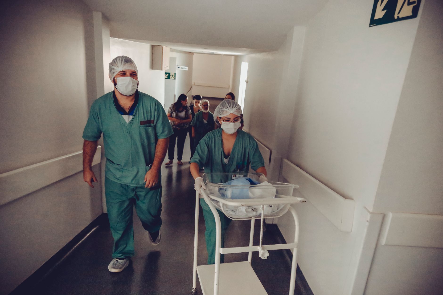 Nurses moving through a bright hospital hallway, reflecting the internal support work ORMC is targeting with routine transport runs.