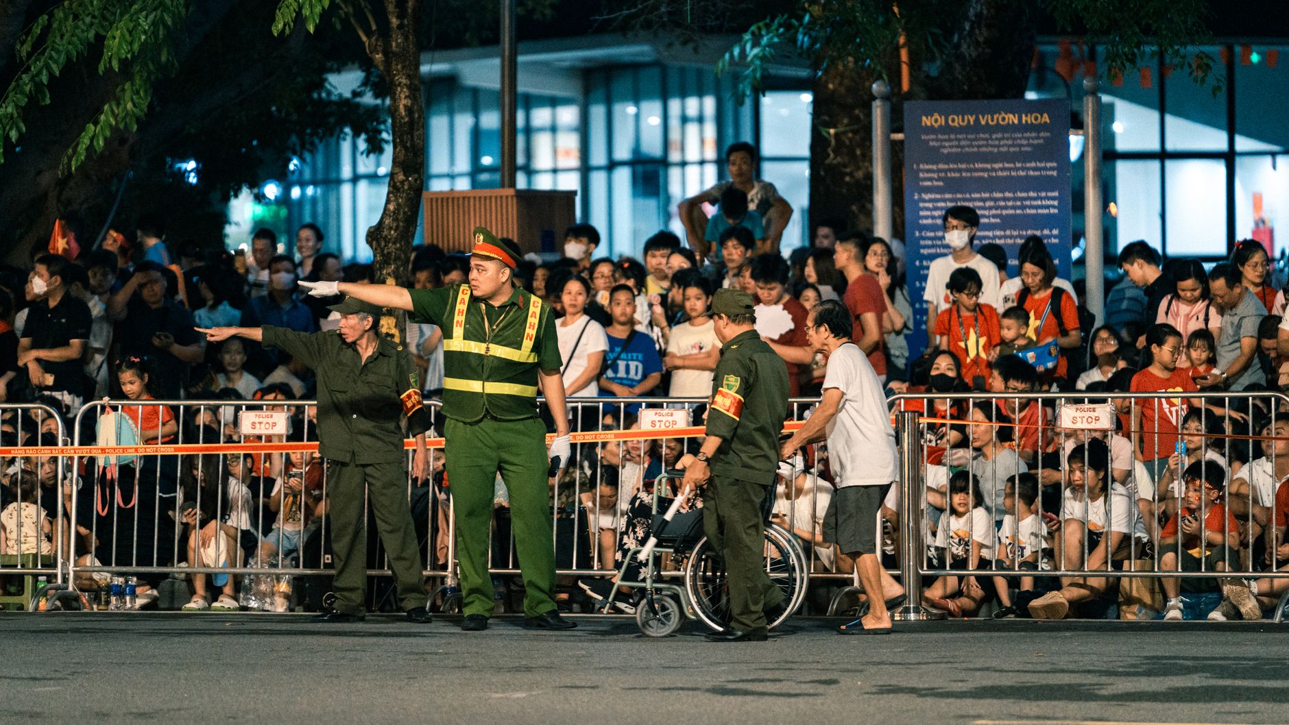 Crowd barriers and venue security highlight liability planning for mobile robots near guests.