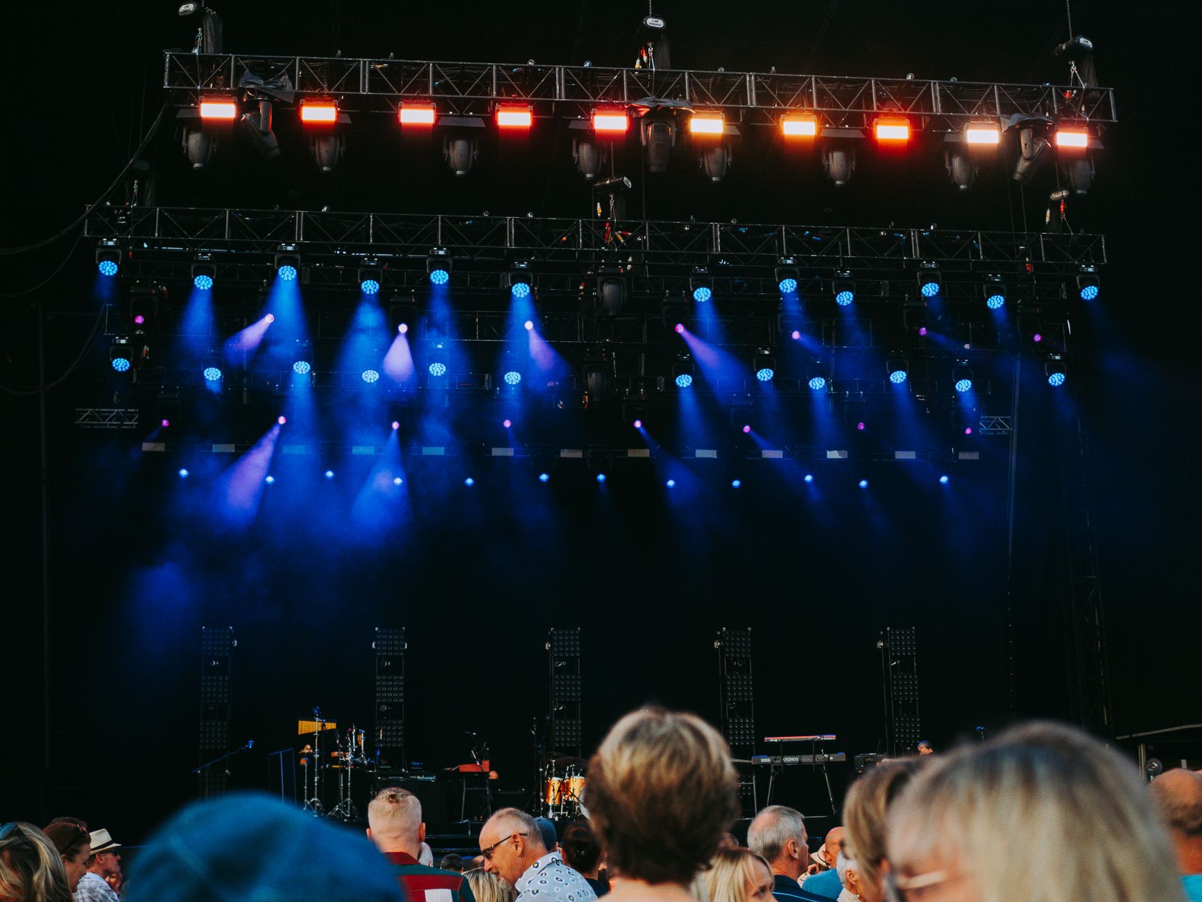 An outdoor evening event stage evokes the kind of paid robot activation reported at a Malibu industry mixer.