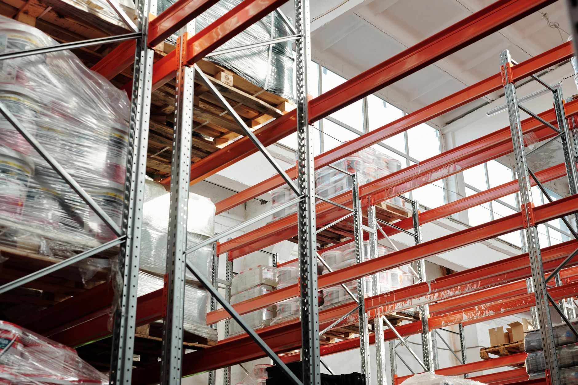 A wide, clean aisle in a modern logistics facility, suggesting the operational environment where automation trends are having an impact.