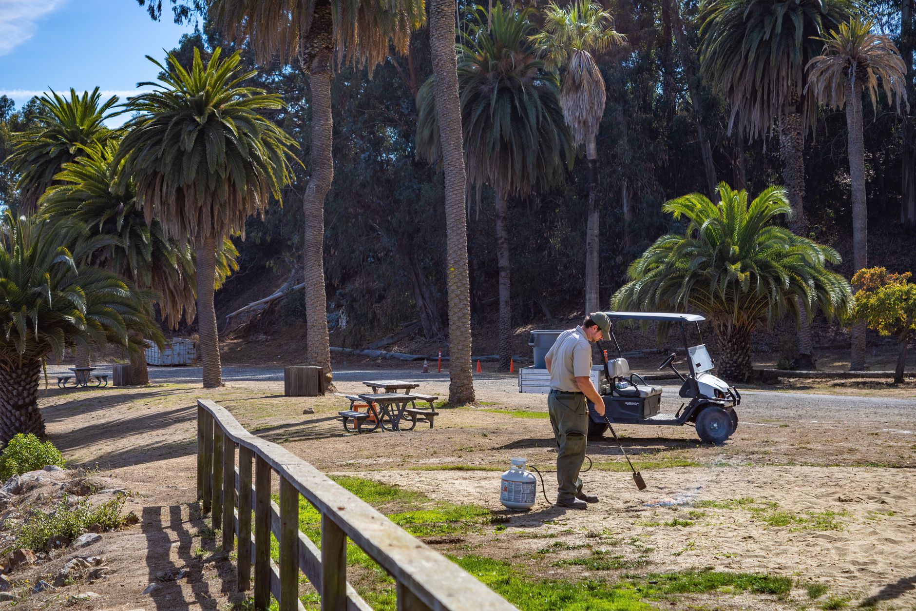 Golf course maintenance buildings near turf, where charging docks and service access are planned.