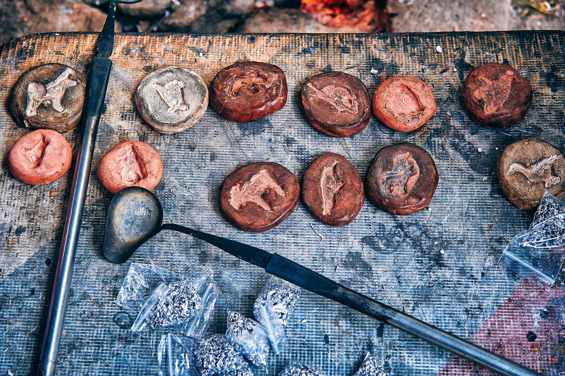Rows of sand casting molds and tooling arranged on a foundry work surface, underscoring the fixturing and changeover realities that determine cell performance.