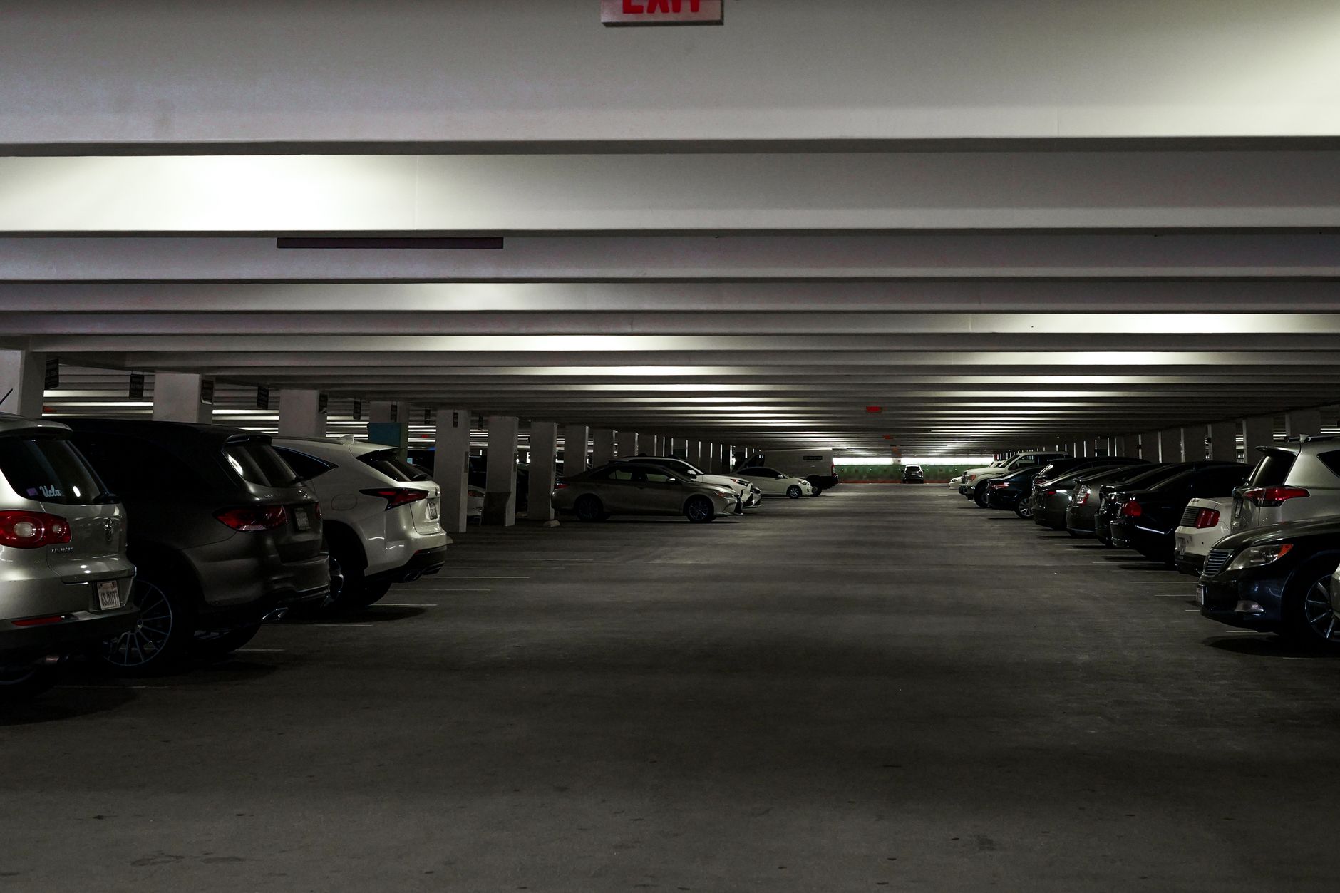 A wide, empty, and well-paved corporate parking garage, an ideal environment for a wheeled security robot patrol.