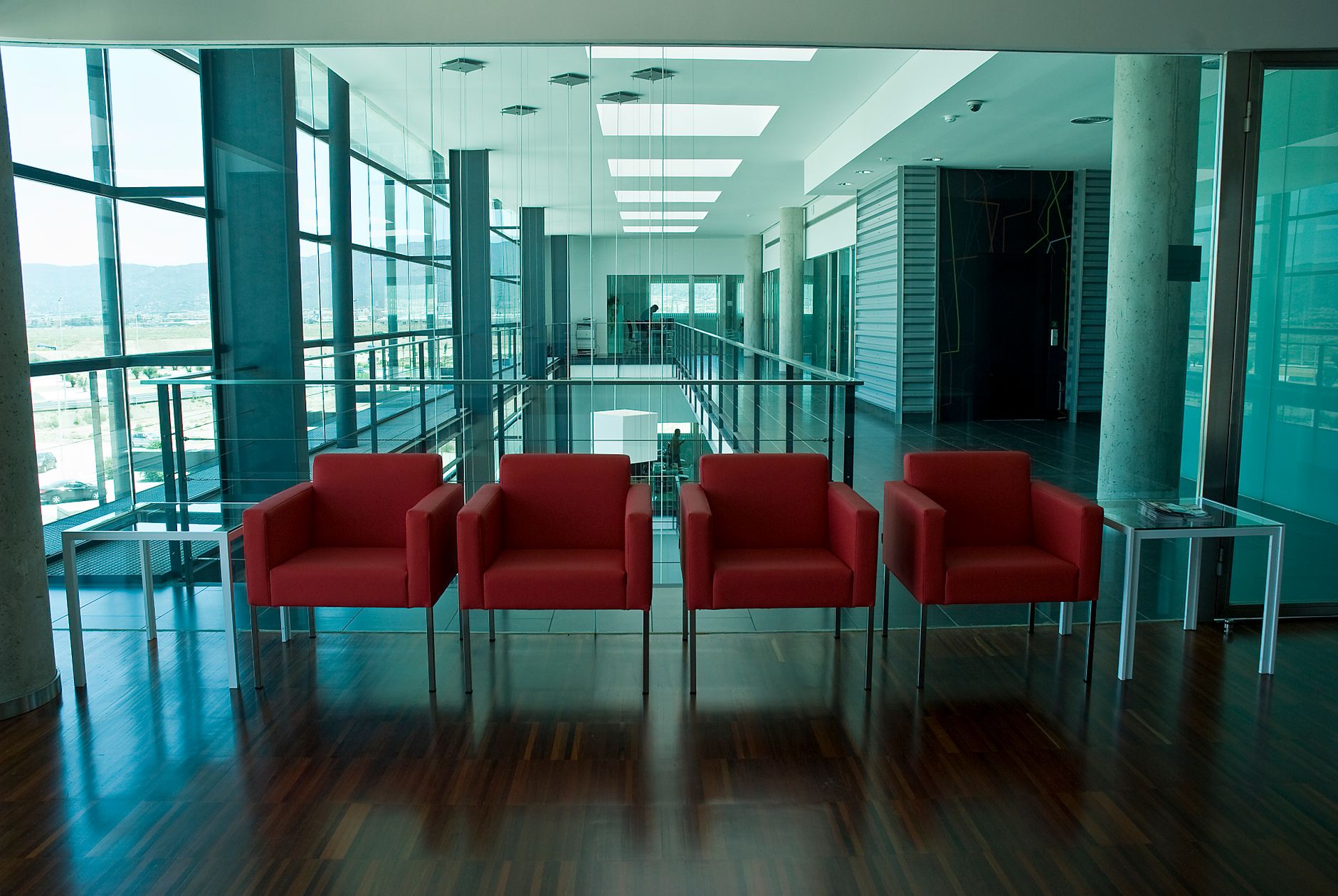 A freshly cleaned office lobby floor with reflections under overhead lights.