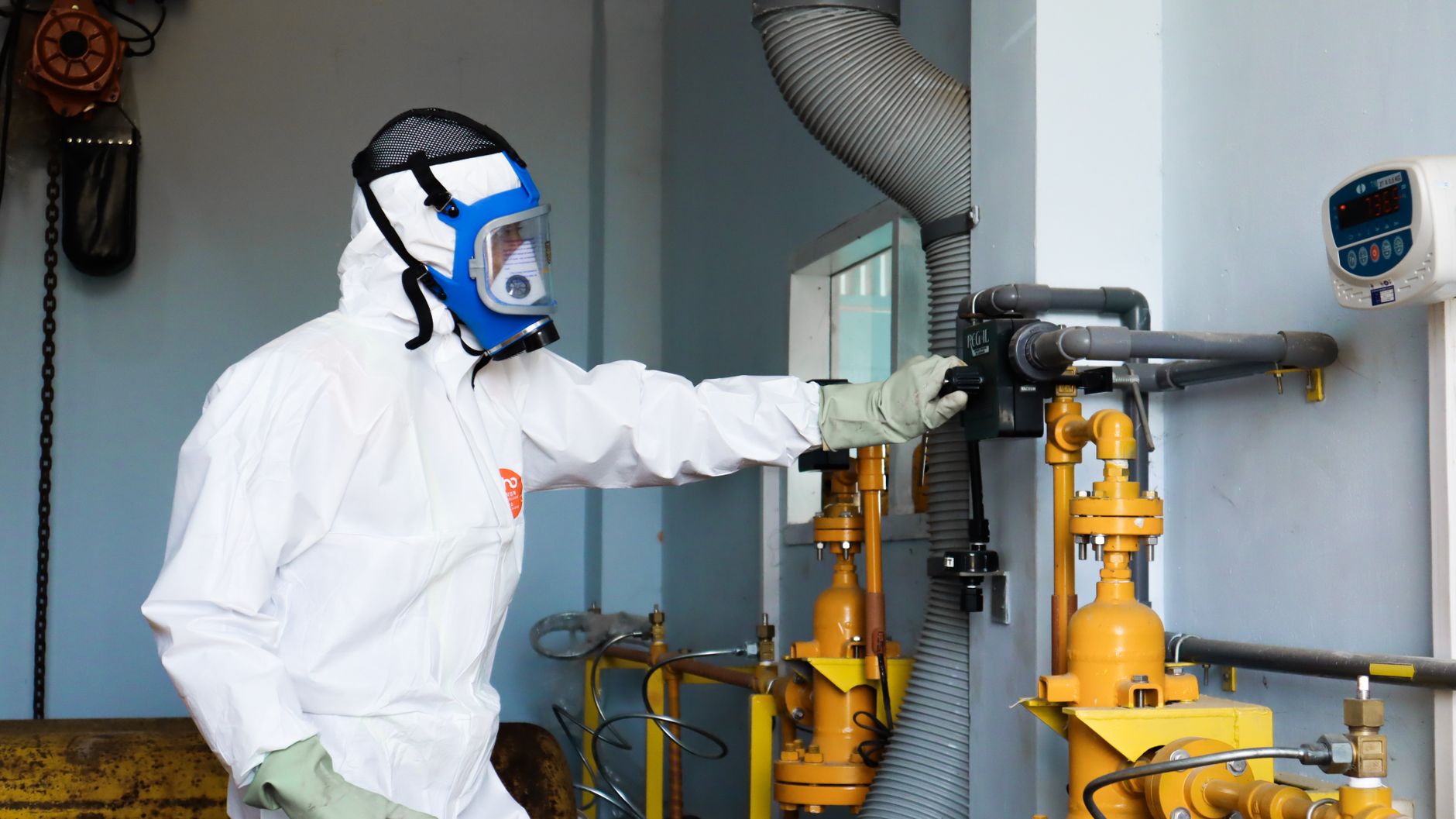 An inspector walks through an industrial plant where repeatable equipment checks could be performed remotely.