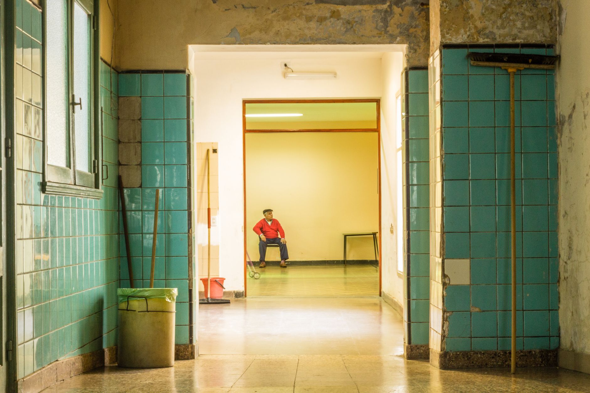 Cleaning staff member checking a clipboard in a commercial hallway, representing the proof-of-work and service-log discipline contractors need overnight.