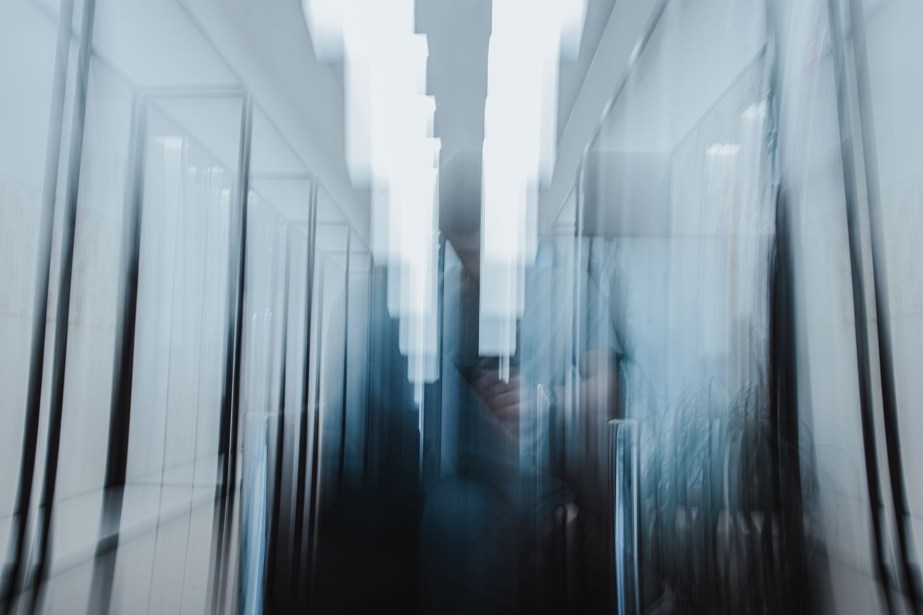 Empty commercial hallway at night, reflecting the overnight cleaning windows that push janitorial firms toward standardized floor-care routes.