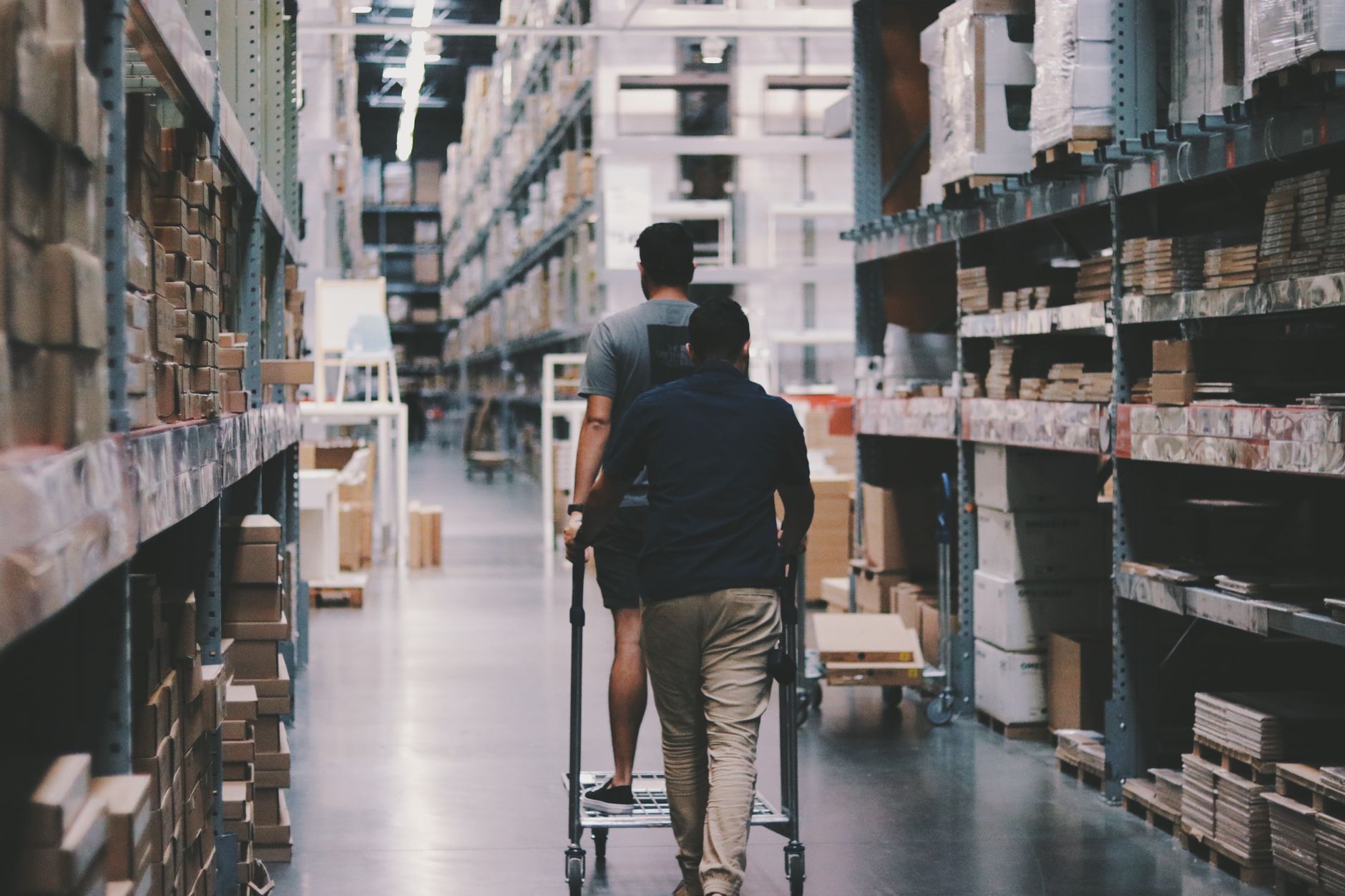 A cramped retail backroom with shelving and a narrow path, highlighting why thresholds, turning space, and congestion matter in site assessments.