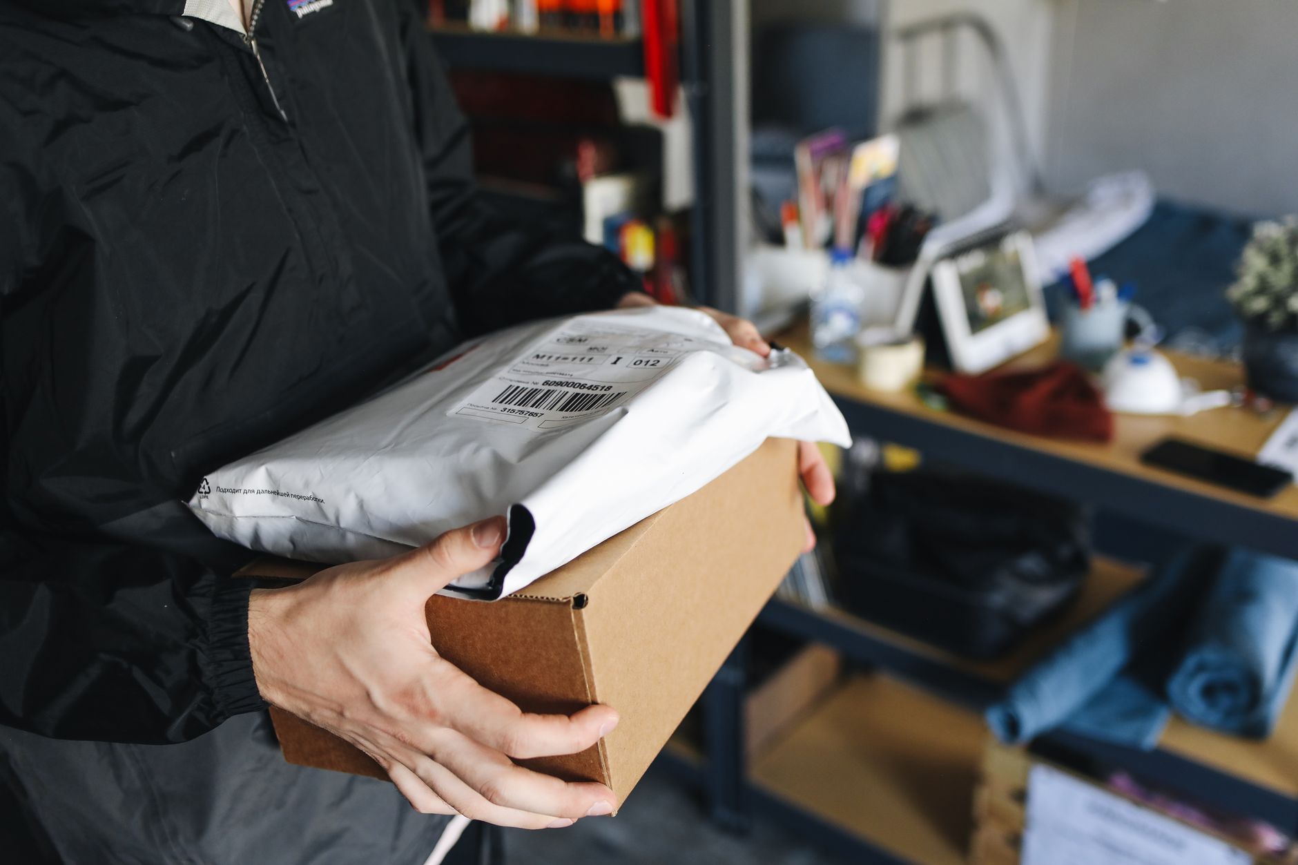 Many stacked cardboard boxes ready for shipment, illustrating the high order volume driven by e-commerce.