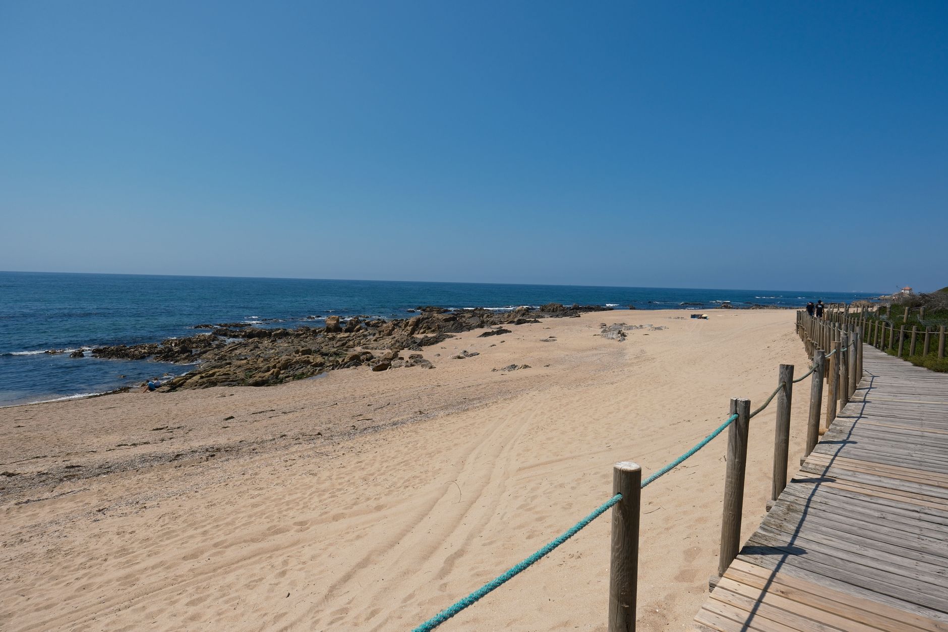 Sandy walkway leading toward a beach