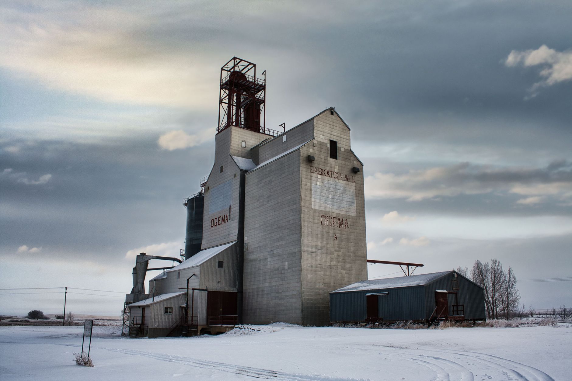 Grain elevator beside a rural highway in farm country