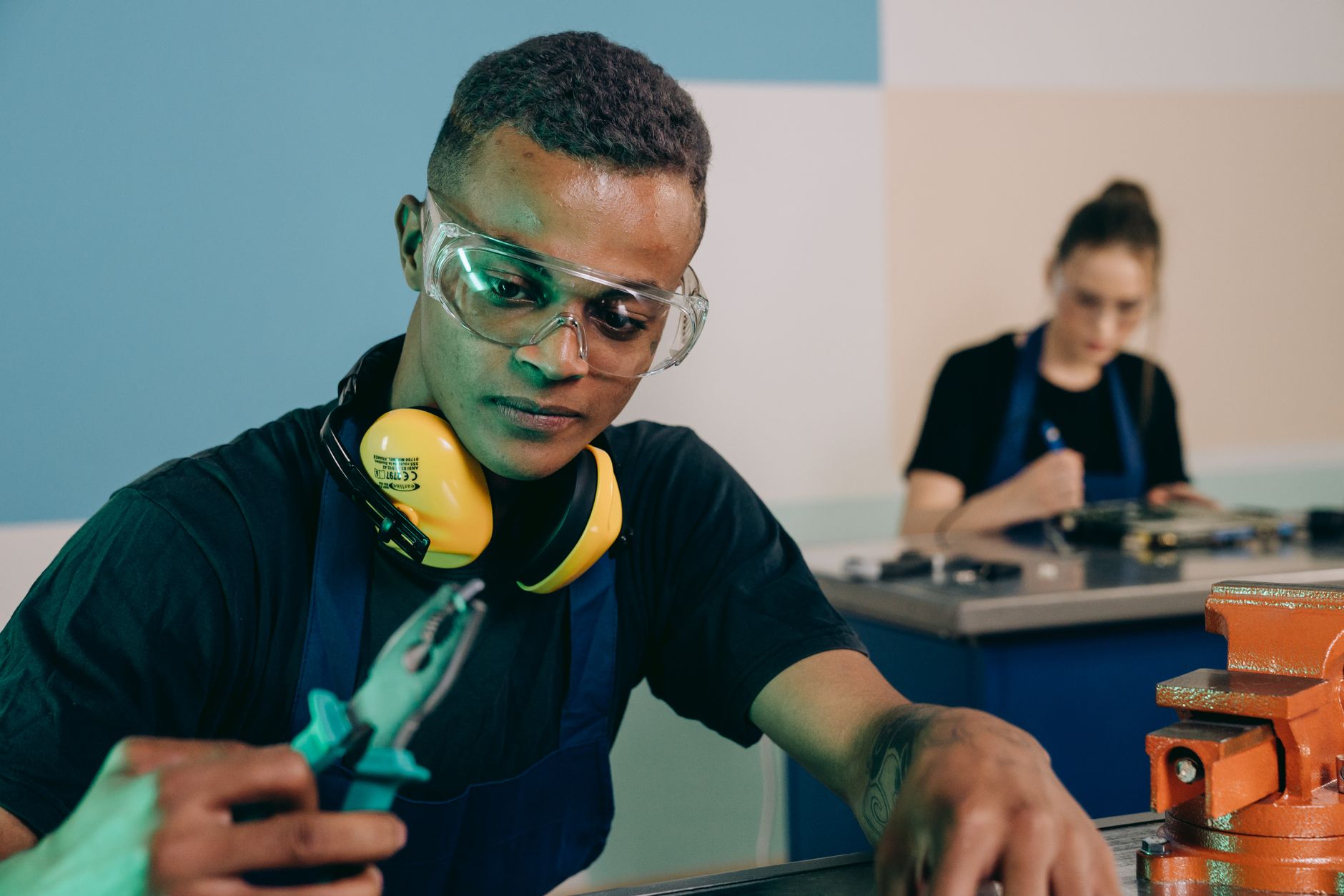 A maintenance technician inspecting equipment in a commercial fitness facility.