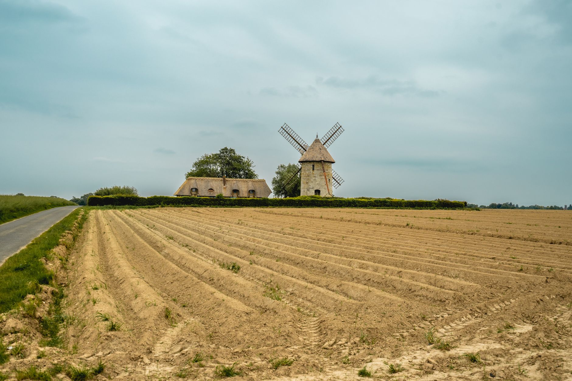 Wind turbines rise above farmland in northern France, establishing the setting for the blade-repair campaign.