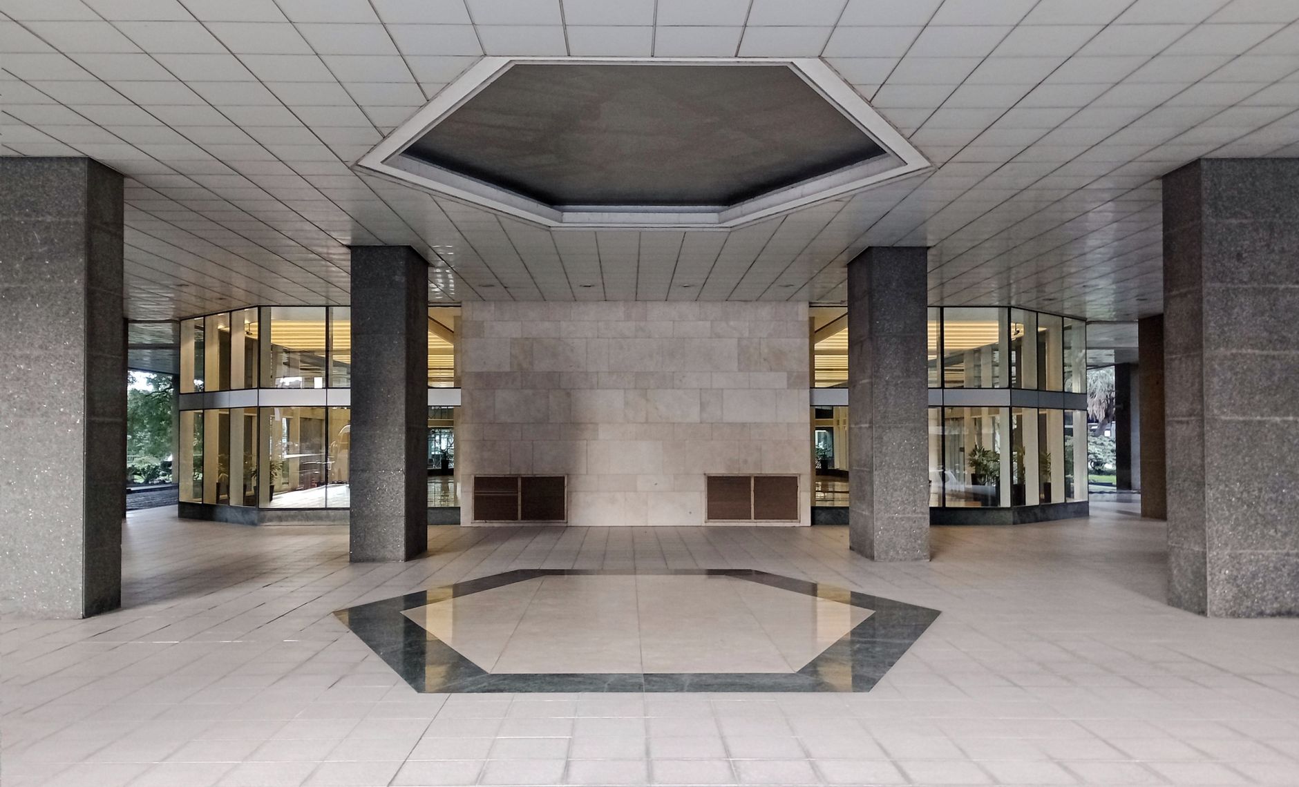 A bright Class A office tower lobby with a front desk and open visitor arrival area.
