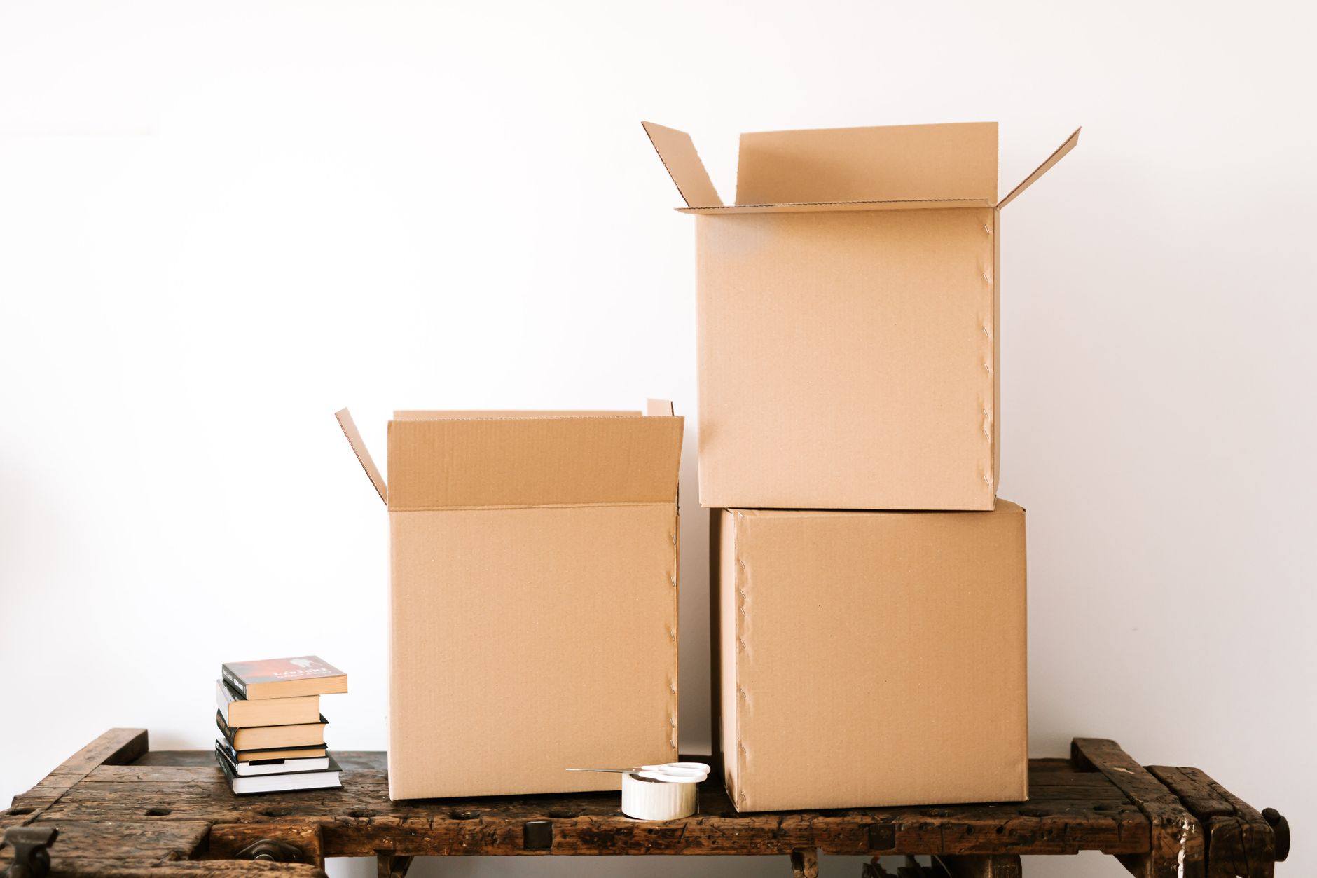 Open cartons and shipping supplies arranged at a packing station, reflecting a fulfillment cell built around box handling and verification work.