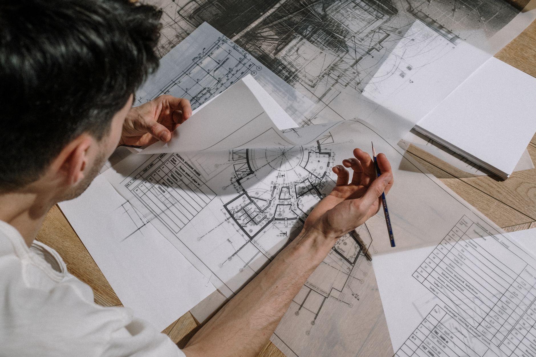 A project manager reviewing documentation instead of walking the site with a camera.
