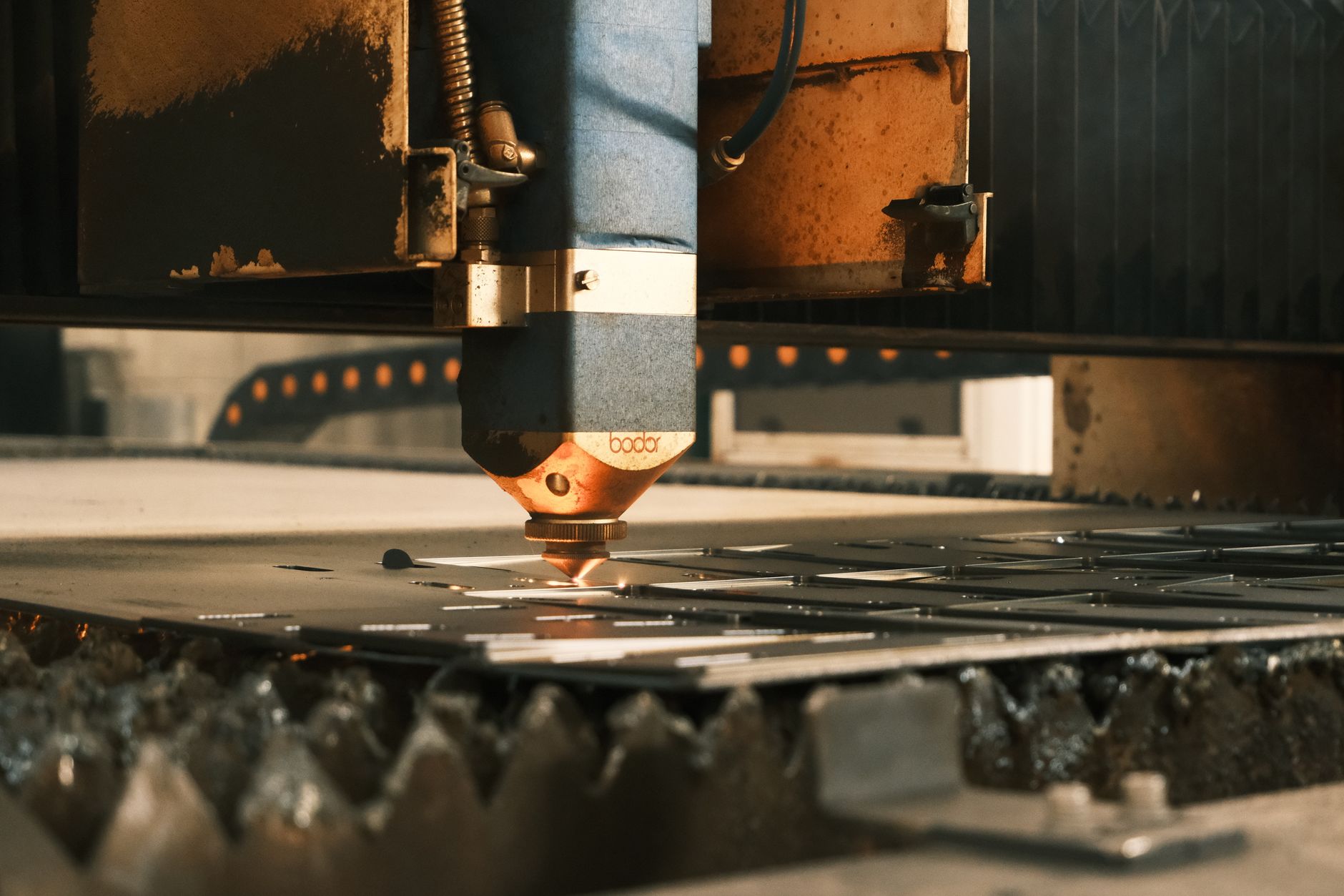 Laser welding and marking steps that modular robot cells took over from manual stations.