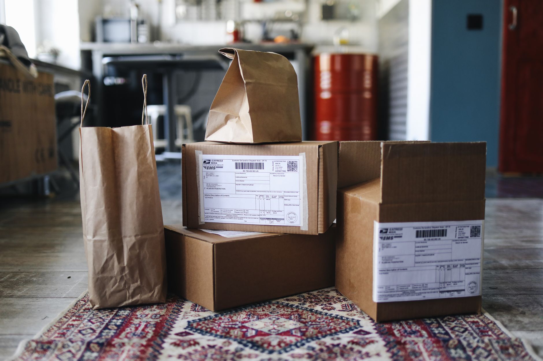 Stacked shipping cartons move through a parcel area after pick rates rose on the floor.