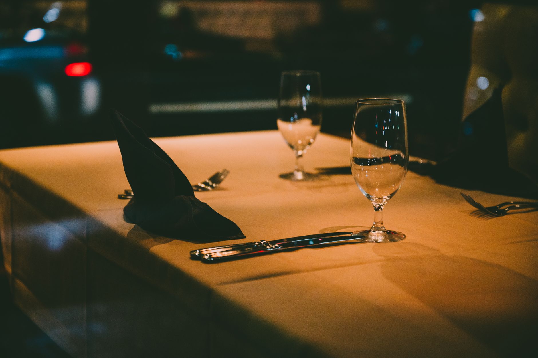 Guests dine during evening service in a large restaurant dining room.