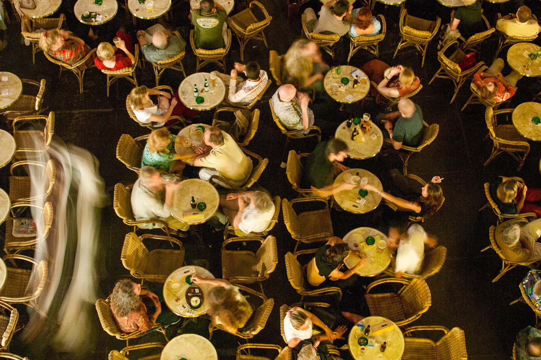 A crowded restaurant interior during a peak weekend service.