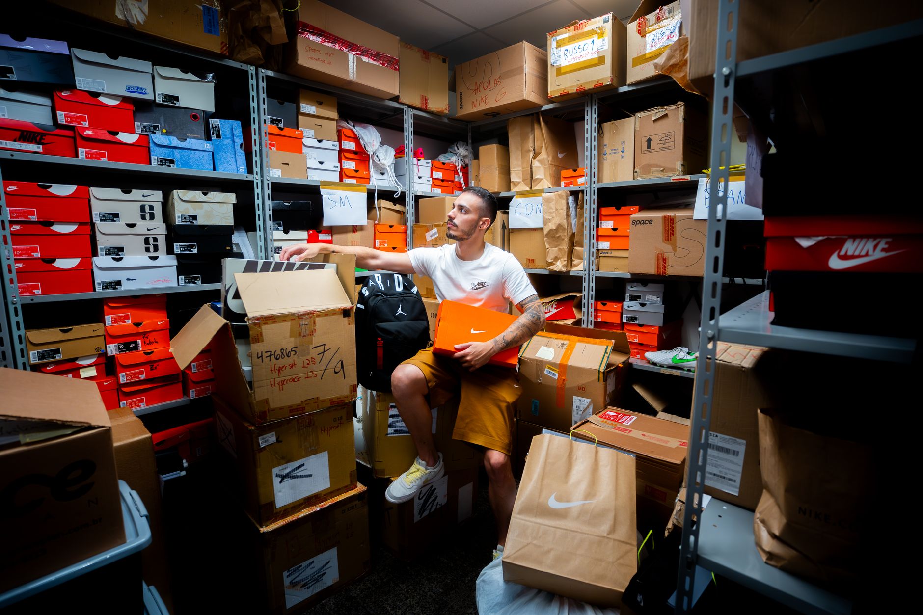 Stacked shoe cartons on warehouse shelving illustrate the high-SKU footwear replenishment module in this case study.