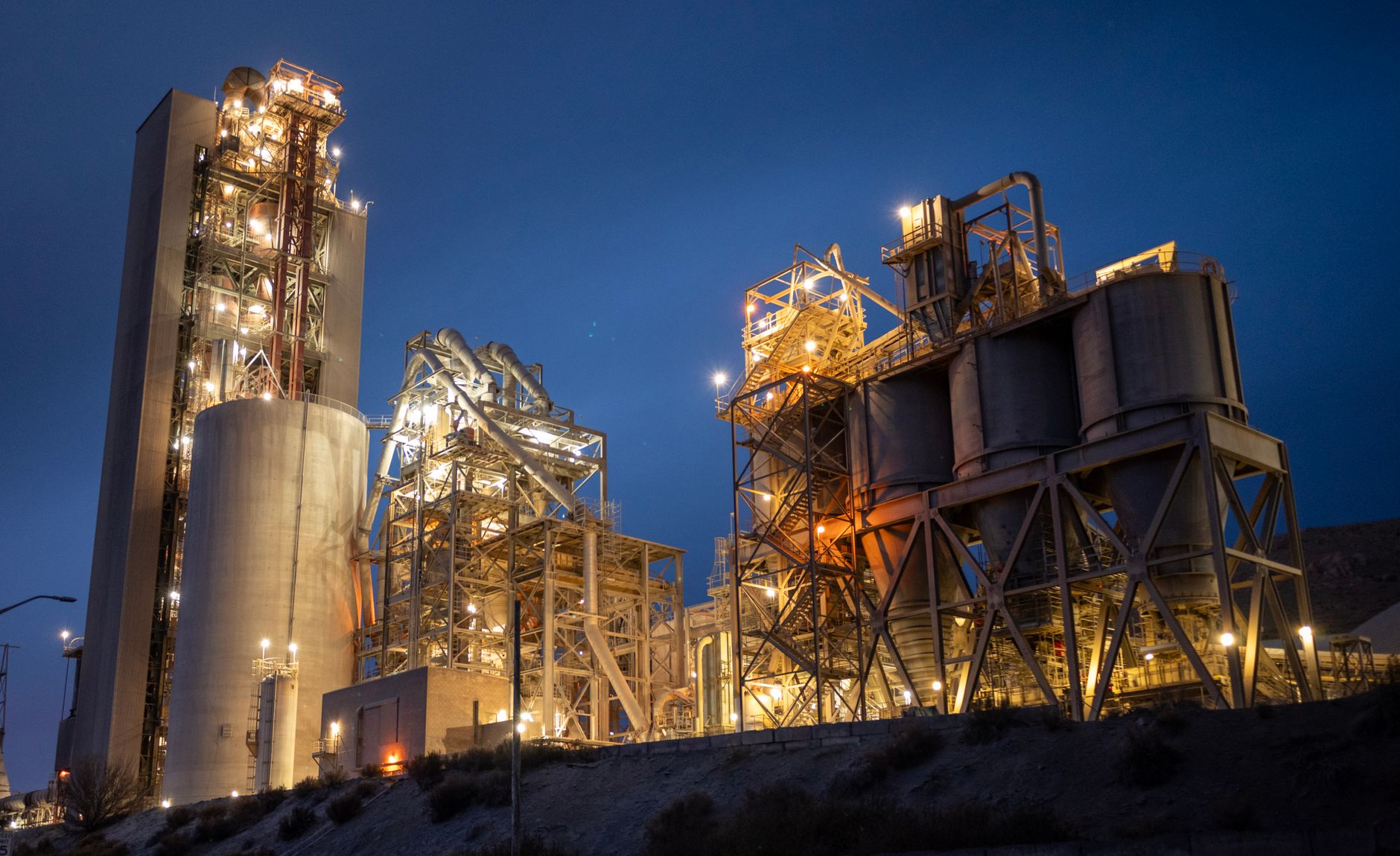 Exterior view of a large cement plant with silos and conveyors, setting the scene for a multi-floor inspection program.