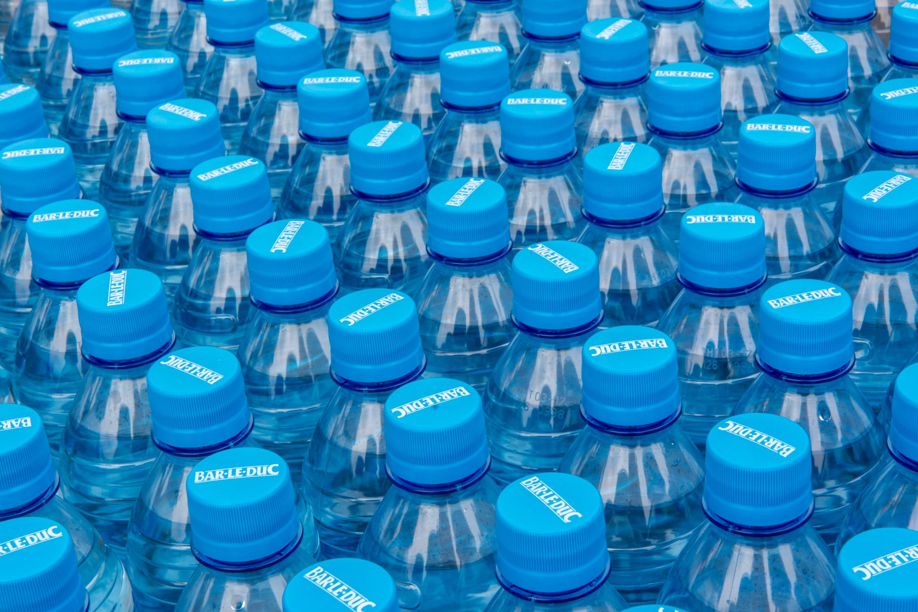 Colorful plastic container closures grouped together for high-volume packaging production.