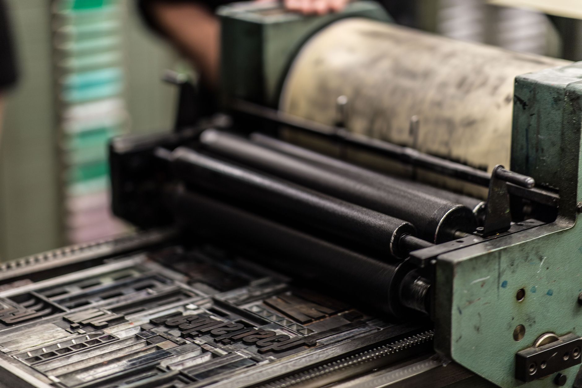 Industrial commercial printing equipment on a busy production floor like a high-mix plant moving hundreds of jobs daily.