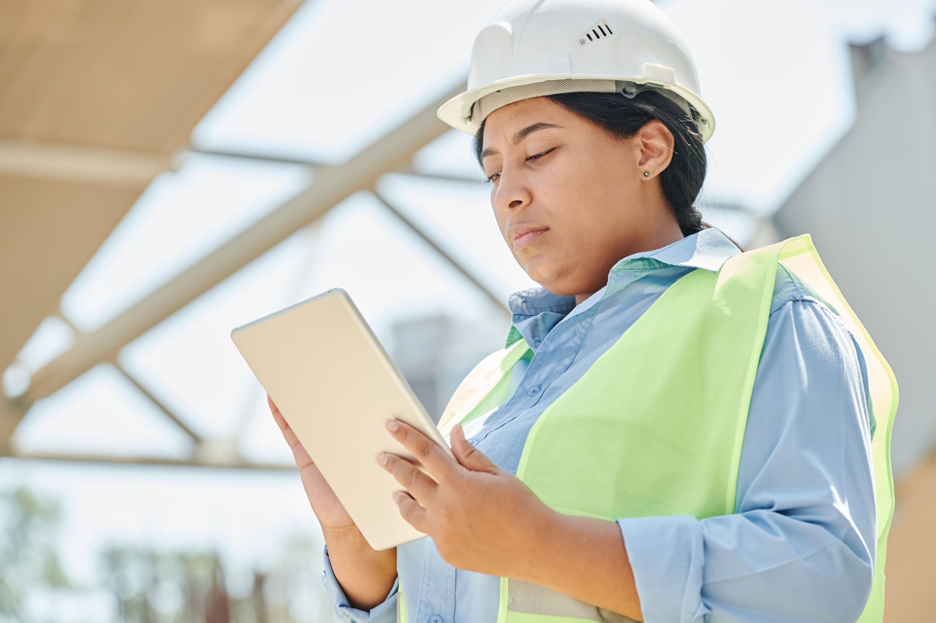 An inspector reviewing survey data on a tablet instead of pacing every roof seam on foot.