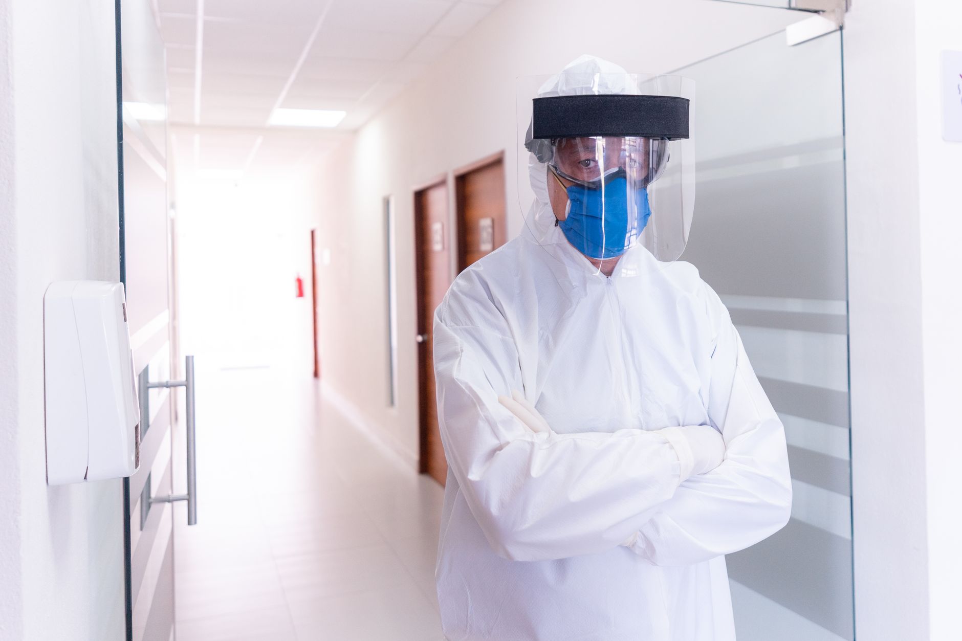 Clinical staff moving through a hospital hallway where EVS teams need predictable floor standards.