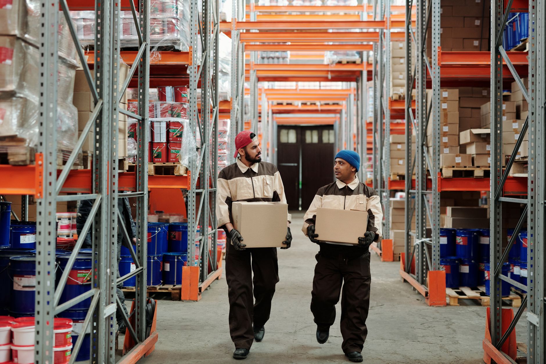 Staff sort and stage packages in a warehouse receipt area.