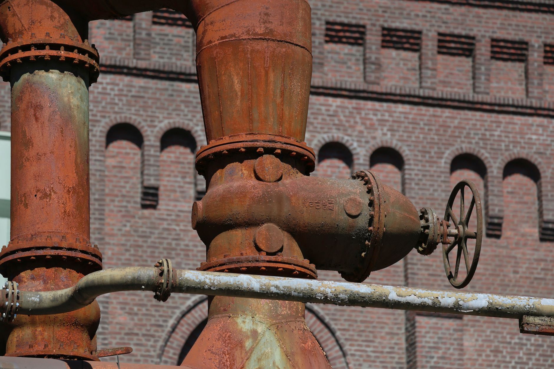 Dense industrial pipework and steel structures illustrate the obstacle-rich environments involved in close-range inspection.