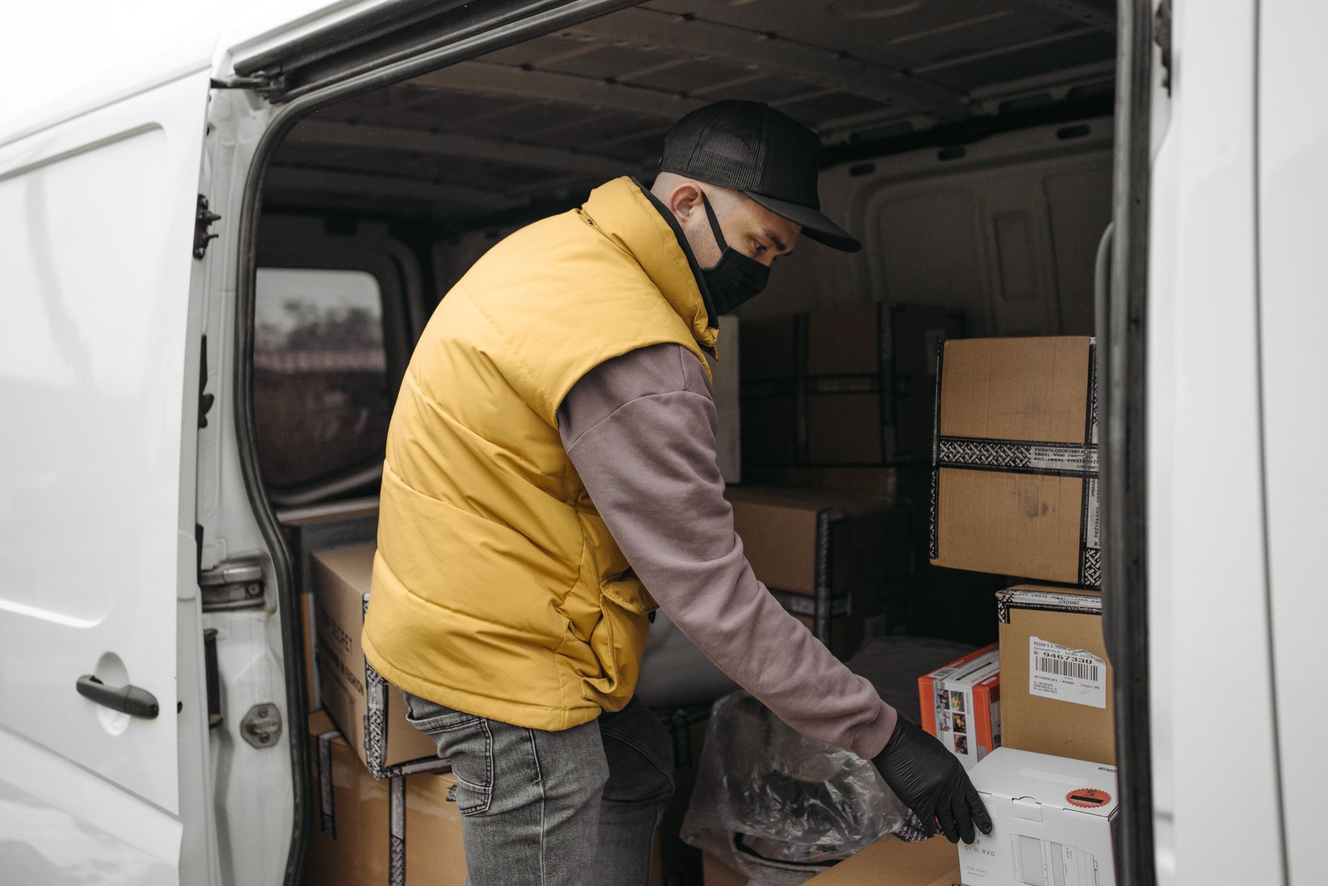 An associate selecting cartons from rack locations, echoing piece-pick work before cart AMRs guided paths.