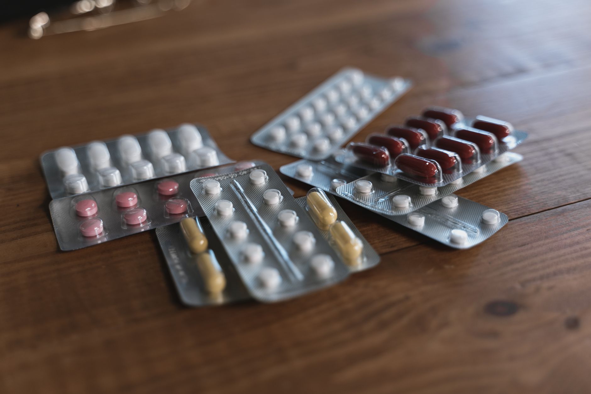 A bright pharmaceutical packaging aisle where bottles move along conveyors, suggesting automated fill-and-label discipline.