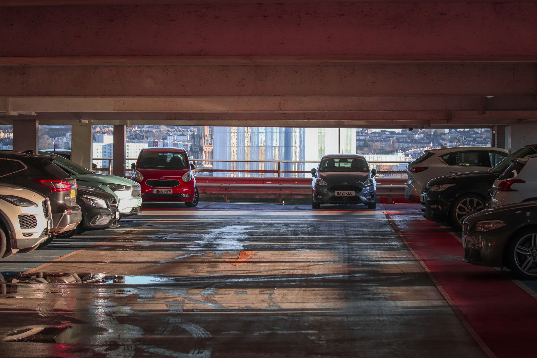 Street-level view of a downtown parking garage entrance, showing the kind of open commercial property where recurring trespassing, theft, and vandalism can take hold.