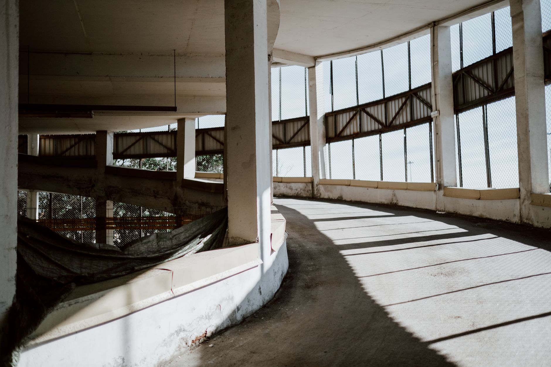 An empty parking deck ramp where mobile patrol coverage reduces blind spots.
