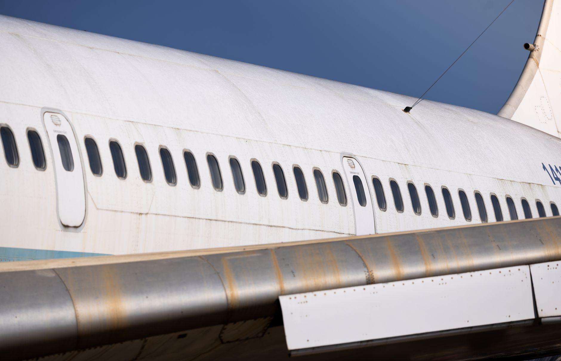 Close view of an aircraft fuselage skin and rivet lines where lightning strike marks would be documented.