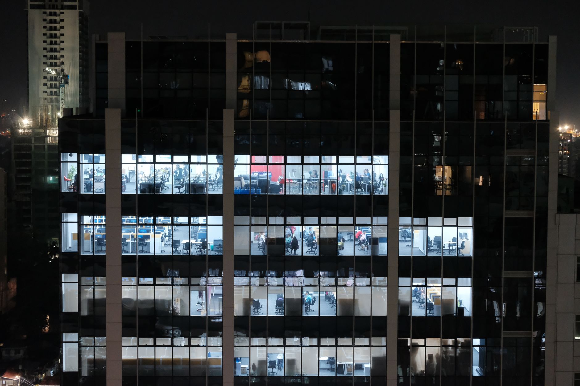 Dimly lit open-plan office floors after staff have left for the night.