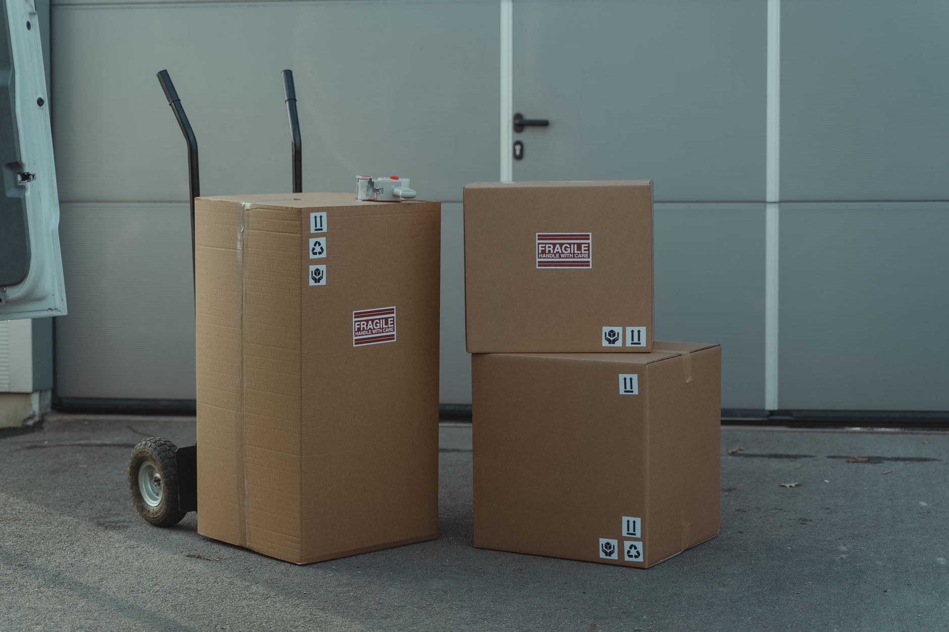 Packed parcels line a fulfillment center staging area.