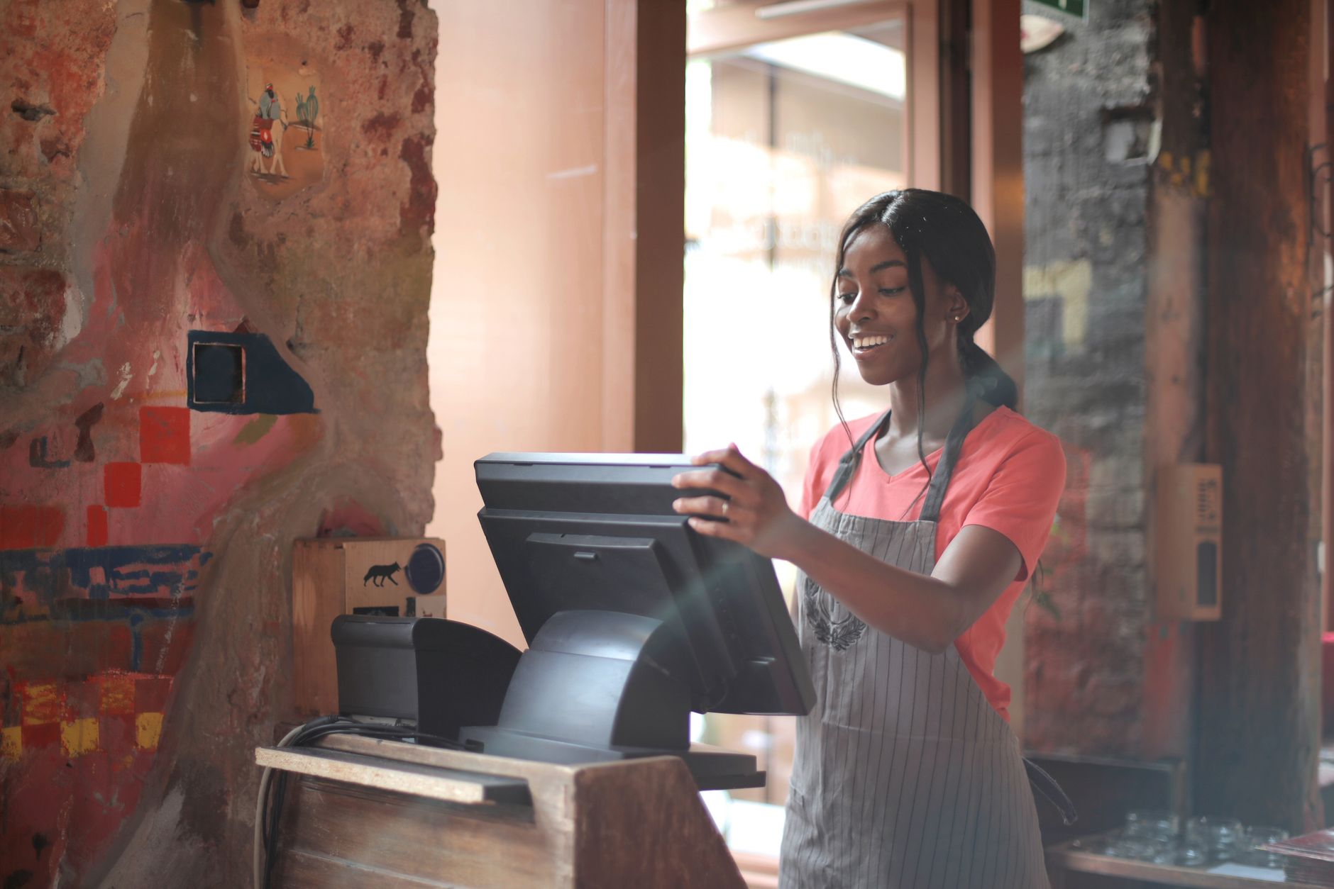 Front-of-house staff watching a dining room and greeting guests in a busy family restaurant.