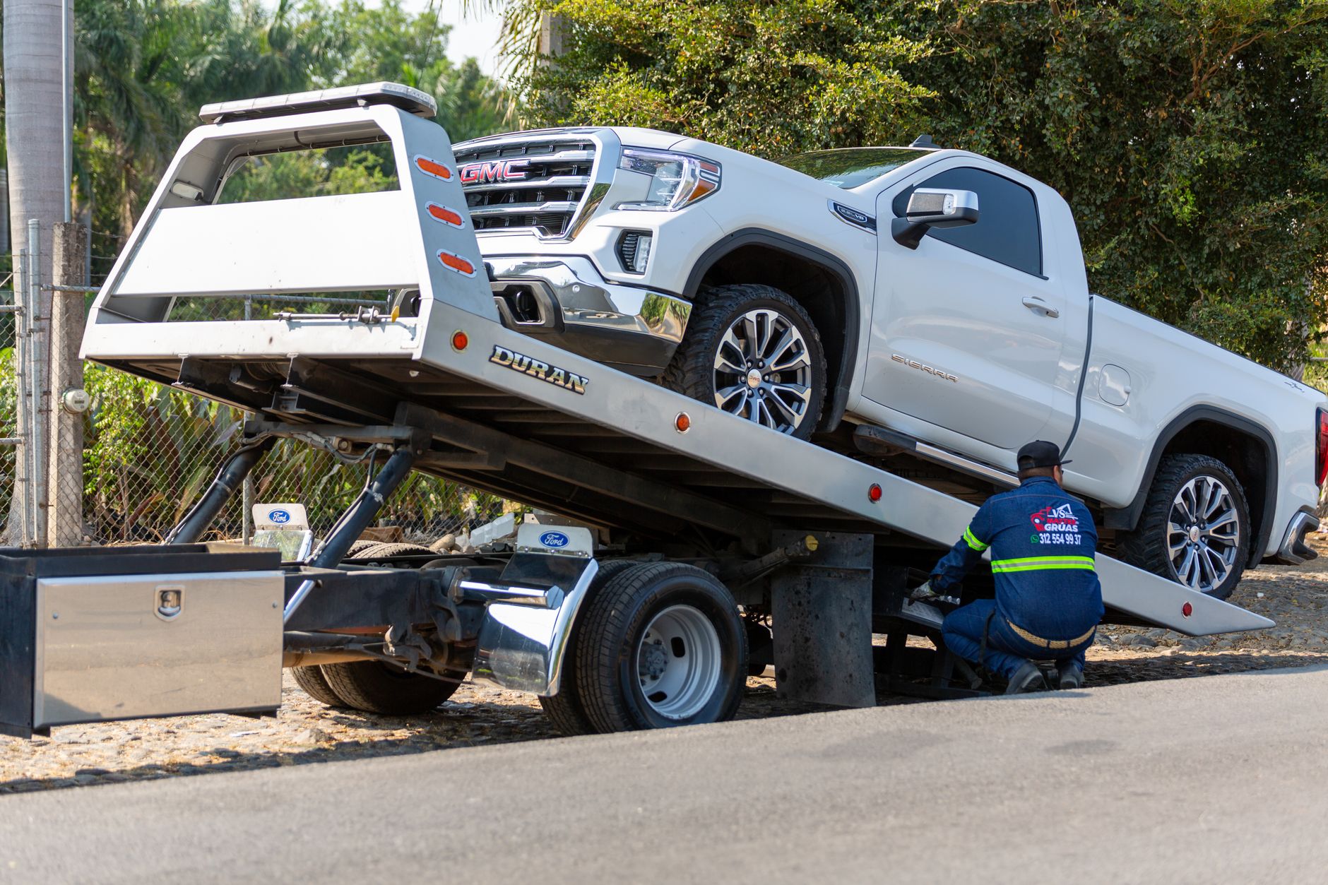 Customers loading bulky purchases into a pickup after a long drive, reflecting shoppers who expect seasonal SKUs to be on the shelf.