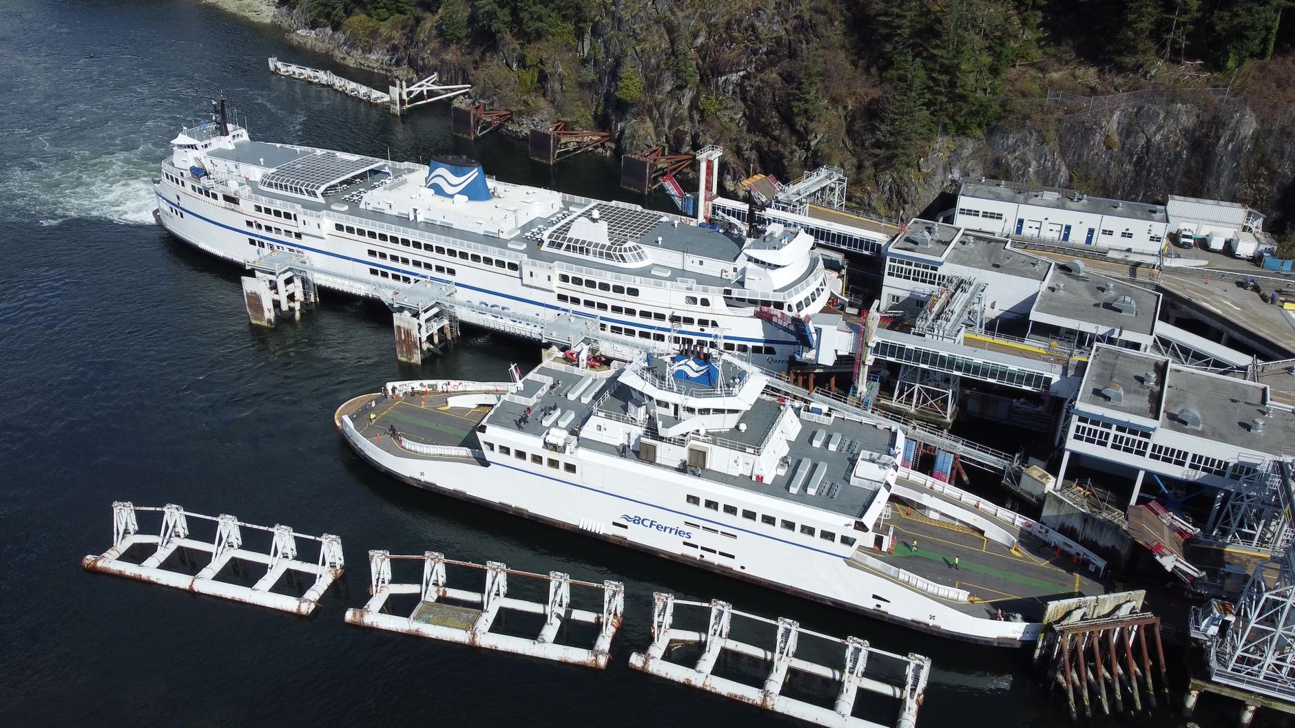 A passenger ferry rests in dry dock with its hull exposed for inspection and cleaning.