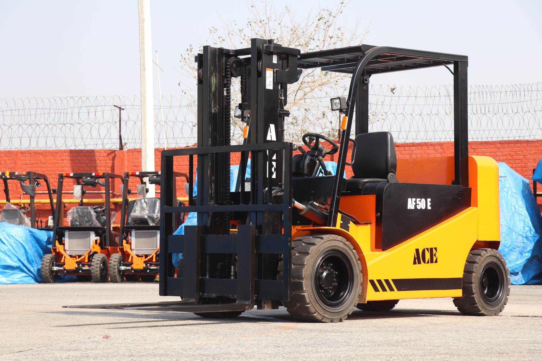 Forklifts and workers moving pallets through a distribution warehouse.