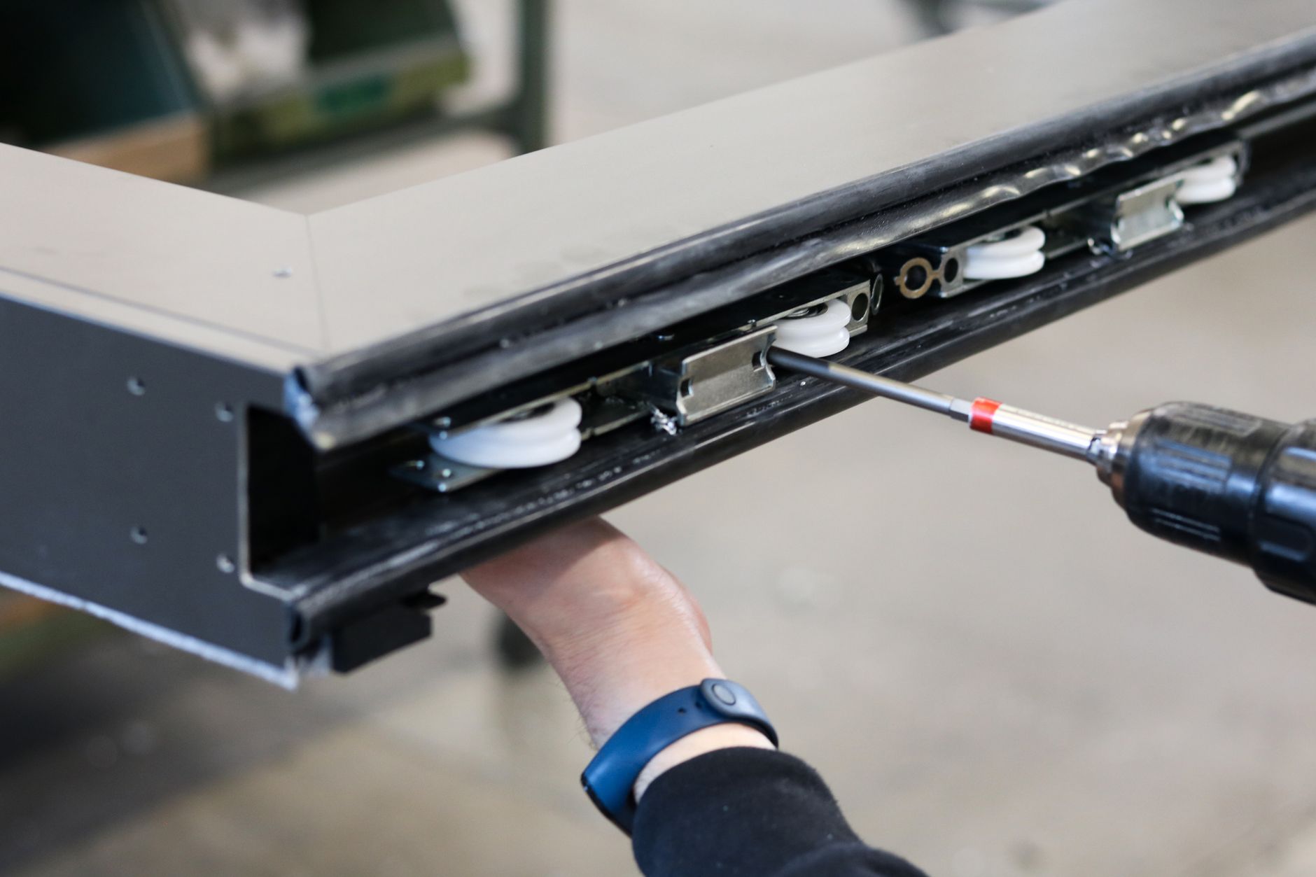 Structural profiles are positioned in a locating fixture on an industrial assembly table.
